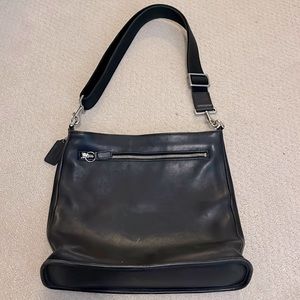 COACH BAG.  Black women’s coach duffle with one strap and zipper.